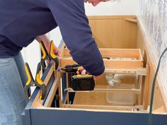 a man is working with tools in his drawer