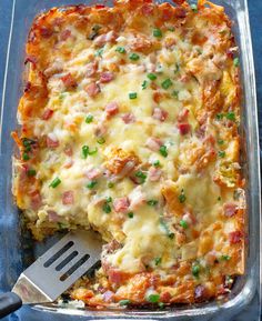 a casserole with ham and cheese in a pan on a blue tablecloth