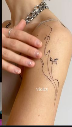 a woman's arm with a tattoo on it and the words violet written in white