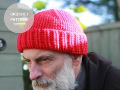 an older man wearing a red knitted hat with the word crochet written on it