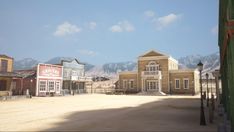 an old western town with mountains in the background