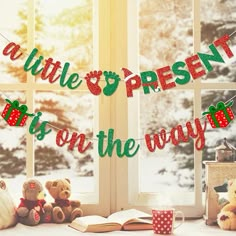 two teddy bears sitting next to each other on a window sill with the words a little present is on the way