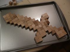 a metal tray with some wooden blocks on it