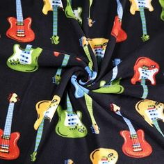 the fabric has guitars on it and is black with multicolored colors, as well as blue