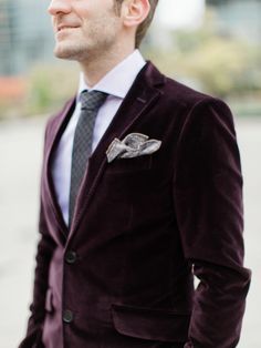 a man in a suit and tie standing outside