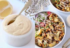 two bowls filled with food next to some dipping sauce