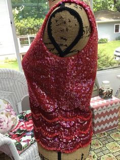 "Vintage 1960s \"GO-GO\" sleeveless beaded/Sequin top. True Red color. Has a full metal zipper in the back with one hook and eye. The tag reads: 100% Wool Hand Beaded in Hong Kong. This top is not lined. CONDITION: Has a small hole in the knit fabric on the right side at the top near the shoulder (SEE PIX). I see a few missing sequins here and here. In the lower back and front (SEE PIX). MEASURES: Bust- 34\"---> 38\" Bottom width-32\"---->36\" Top of shoulder down in the front-21\" In back Red Sleeveless Tops For Party Season, Glamorous Red Sleeveless Top, Festive Sleeveless Dress With Contrast Sequins, Festive Sleeveless Sequin Dress With Contrast, Red Embellished Sleeveless Top, Red Fitted Tank Top For Party, Sleeveless Contrast Sequin Festive Dress, Festive Sleeveless Contrast Sequin Dress, Sleeveless Contrast Sequin Dress For Festive Occasions