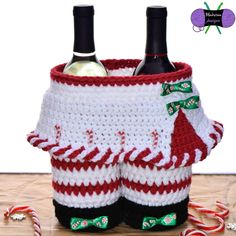 two wine bottles in a crocheted basket with candy canes