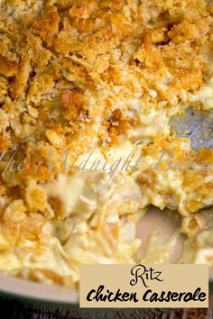 a casserole dish filled with chicken and crumbs on top of a wooden table