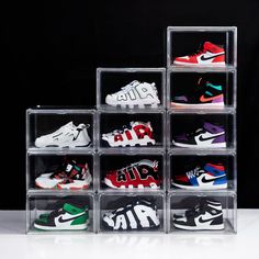 six clear acrylic boxes filled with different colored nike shoes on black back ground