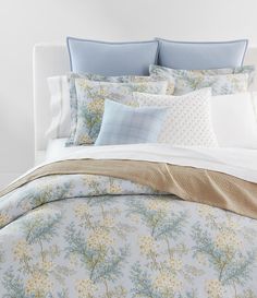 the comforter is made up with blue and yellow flowers