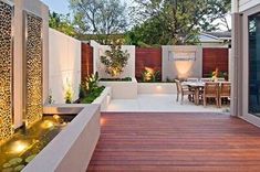 an outdoor patio with wooden decking and lighting