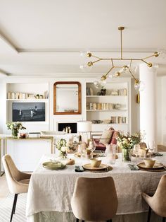 a dining room table is set with plates and bowls