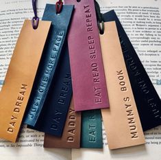 six leather bookmarks with words on them