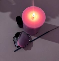 a lit candle and some other items on a table