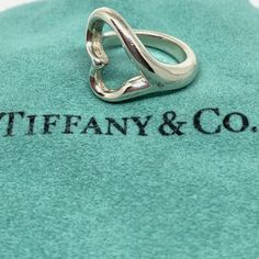 Description Tiffany & Co. Sterling Silver Elsa Peretti Open Heart Ring Size 4.5 Weight: 70.8 Grams Size: 4.5 Wide: Approx 19mm Hallmarks: Tiffany & Co. Peretti 925. Condition: Pre-Owned Minor Signs Of Wear Metal: Sterling Silver Open Heart Ring, Jewelry Tiffany, Elsa Peretti, Tiffany Co Jewelry, Open Heart, Womens Jewelry Rings, Tiffany & Co., Heart Ring, Ring Size