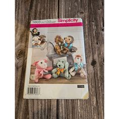 a magazine with stuffed animals on it sitting on a wooden table next to a wall