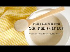 a white bowl filled with oat baby cereal next to a yellow and white towel