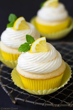 cupcakes with white frosting and lemon slices on top