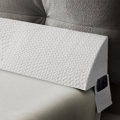 a close up of a bed with a pillow on it