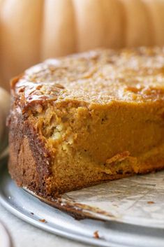 a close up of a piece of cake on a plate next to some pumpkins