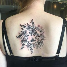 a woman with a sun and moon tattoo on her back