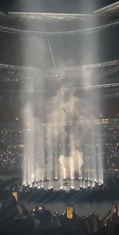 fireworks are lit up in the middle of an arena