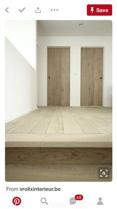 an empty room with two wooden doors in it