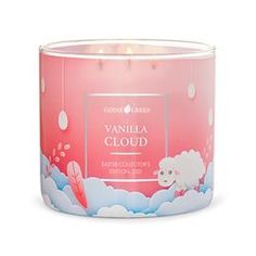 a candle that is inside of a pink tin with clouds and sheeps on it