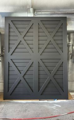 an image of a garage door that is being painted black and has the doors open