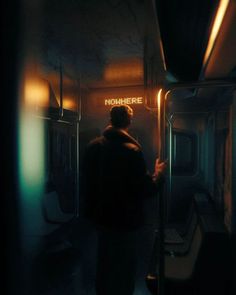 a man standing on a train looking out the window