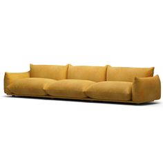 a yellow couch with four pillows on it's back and one arm facing the camera