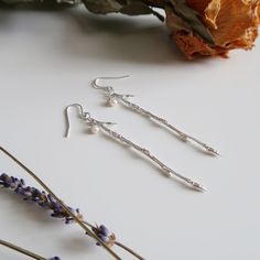 Depending on availability in stores, please allow 3-4 weeks for your order. Silver dangle and drop earrings featuring delicate yet striking branches and a 3.5 mm pearl hanging from minimal silver earring hooks. These earrings were made from a process called organic casting. A real branch is molded and then cast in sterling silver, capturing and preserving all the intricate details and textures of the natural material. Dimensions:- Length: 3 inches Materials:- 925 sterling silver- 2 x 3.5 mm roun Branch Earrings, Earring Hooks, Silver Earring, Natural Material, Intricate Details, Natural Materials, Bobby Pins, Silver Earrings, Hair Accessories