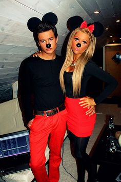 a man and woman dressed up as mickey mouse and minnie mouse with their mouths open