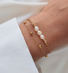 This double row bracelet is delicately made with high quality natural freshwater pearls. Ideal for bringing an elegant and chic style, it is perfect for a gift (wedding, birthday) for someone or for yourself (-: - Details - . Materials: - Freshwater pearl 5×4mm - Gold stainless steel chain - Gold stainless steel clasp . Length of bracelet: 15.5cm plus a 4cm extension chain. . The chain and lobster clasp allow the bracelet to be perfectly adjusted to the size of the wrist (wrist circumference from 14cm to 18cm). If you want another size, do not hesitate to leave me a message to tell me the desired length. . The bracelet is sent (by registered letter) with an organza bag. If you mark the order as a gift, I will put the bracelet in a gift bag closed with a sticker before posting it. . The sto Pearl And Gold Bracelet, Double Bracelet, Pearl Bracelet Gold, Gold Chain Bracelet, Bracelet Wedding, Freshwater Pearl Bracelet, June Birthstone, Gold Bracelet Chain, Chain Gold