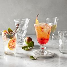 several glasses with different types of drinks in them on a marble counter top and below the words glassware collections