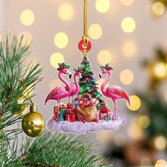 an ornament hanging from a christmas tree decorated with flamingos