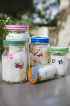 three jars filled with white rice sitting on top of a table