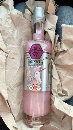 a bottle of pink liquid sitting on top of some paper