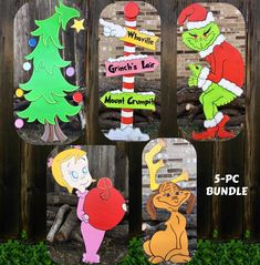 the grinch's christmas tree cutouts are on display in front of a fence