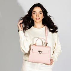 Feminine Pink Top Handle Bag -Chic & Versatile. Introducing our latest collection addition, Layla Bag in Pink. Lean into the femininity of a soft pink bag, perfect for spring and summer. This new-season Enjoy the versatility of Layla Bag with its adjustable strap, allowing you to wear it comfortably as a crossbody or shoulder bag, depending on your style preference. Bag Specifications Material: Vegan leather Interior: Luxurious suede lining Handles: Single handle, Removable shoulder strap Hardware: Golden-tone metal flap Pockets: One inner zipped pocket Closure: Front flap closure Size and Fit- Height: 20 cms / 7.9 In Handle Height: 10 cm / 3.9 In Width at bottom: 26 cm / 10.2 In Depth at bottom: 11 cm / 4.3 In Adjustable strap length: 55-60 cms / 21.7-23.6 ins Luxury Spring Bag With Top Carry Handle, Chic Flap Bag With Removable Pouch For Daily Use, Chic Satchel Flap Bag With Removable Pouch, Chic On-the-go Shoulder Box Bag, Luxury Spring Shoulder Satchel, Luxury Spring Satchel Shoulder Bag, Luxury Spring Bags For On-the-go, Chic Double Handle Flap Bag For Shopping, Chic Satchel With Removable Pouch And Top Handle