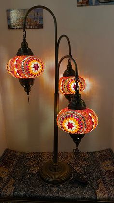 three colorful lights are on top of a lamp post in the corner of a room