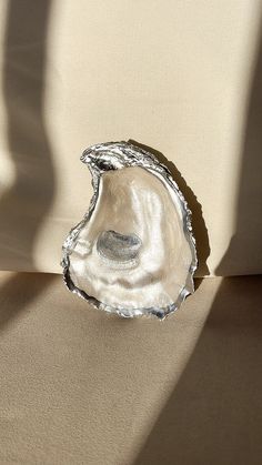 Handmade silver trim Mother of pearl inspired Oyster Shell Trinket Jewelry Dish/Holder. Discover the distinctive charm of our Oyster Shell collection! Each shell boasts a unique touch with individually selected patterns and meticulously adorned with golden accents. All shells vary from shape and size from 2-4 inches, if you prefer a certain size/ shape please add it to order notes.  🎁 Gift a personalized touch to brides, mother of the groom gifts, family members, friends, or treat yourself. These one of a kind crafted shells bring a touch of sophistication to birthdays, gatherings, parties, or make for exquisite wedding favors. Transform any space with a coastal ambiance - ideal for displaying jewelry, on tables, sinks, or dressers. They are versatile, serving as elegant holders for rings Oyster Shell Jewelry, Oyster Jewelry, Brides Mother, Shell Carving, Displaying Jewelry, Shell Trinket Dish, Oyster Shell Crafts, Groom Gifts, Trinket Jewelry