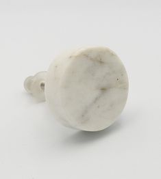 a white marble door knob sitting on top of a table