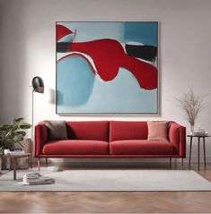 a living room scene with focus on the red couch and large abstract painting above it