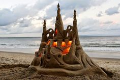 a sand castle made to look like it is on the beach with candles in it