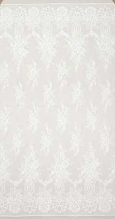 a white and pink floral wallpaper with flowers on the bottom half of it,