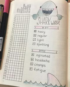 an open notebook with writing on it and a shark week checklist in the middle