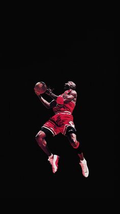 a basketball player jumping in the air with a ball on his hand and wearing red shoes