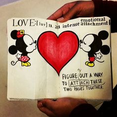 someone is holding up a book with mickey and minnie mouses on it, which reads love truly in an inner attachment